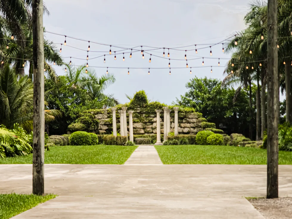 Garden path strung with warm lights for an evening function