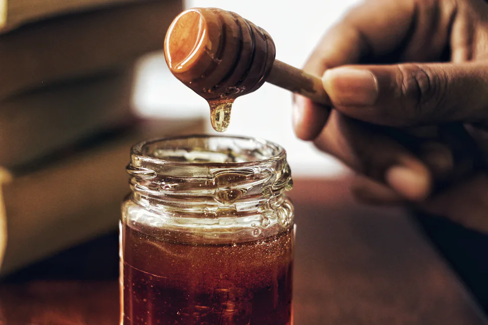 Jar of raw honey with honeycomb