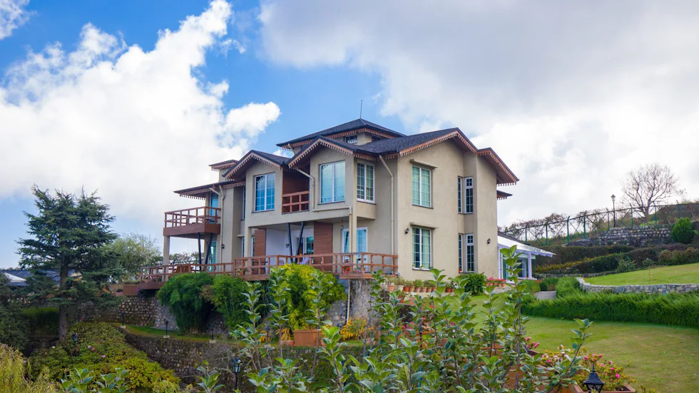 Farm villa overlooking a wide lawn and flower beds